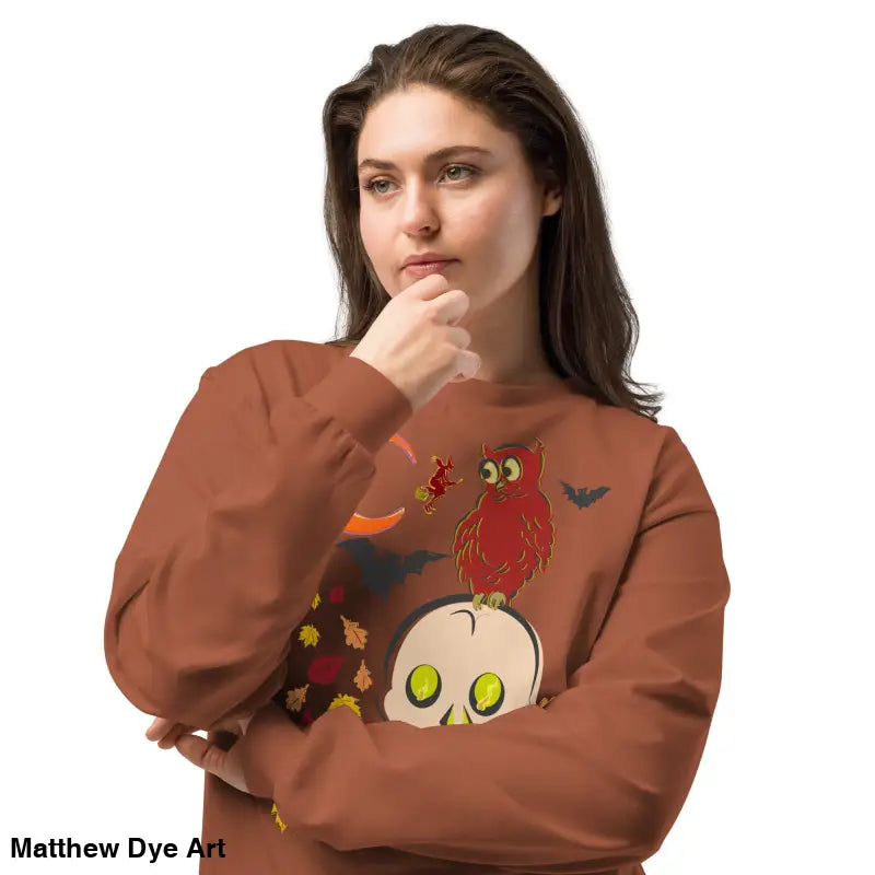Woman in Halloween sweatshirt featuring vintage owl and skull art design