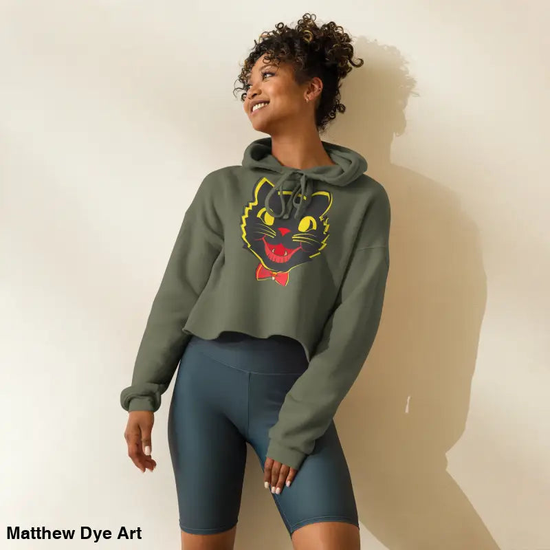 Woman in a stylish vintage black cat crop hoodie featuring a whimsical design