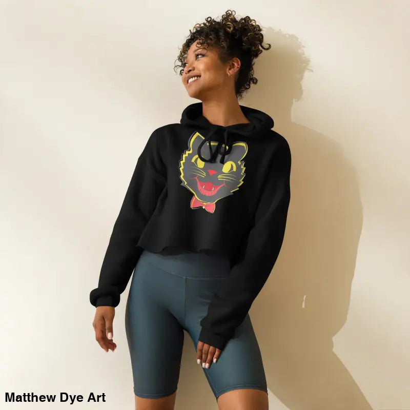 Woman wearing stylish vintage black cat crop hoodie and blue shorts for Halloween