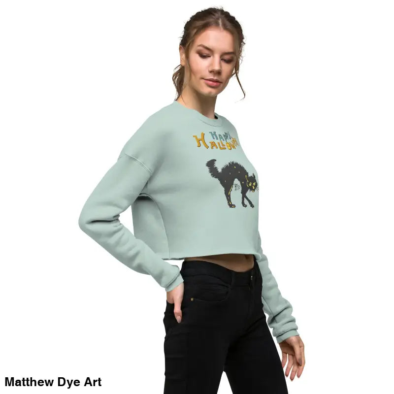 Woman’s cropped sweatshirt in enchanting mint green featuring a scary cat Halloween design