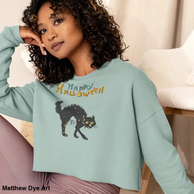 Light blue Halloween sweatshirt featuring a scary cat design from Witchy & Wild