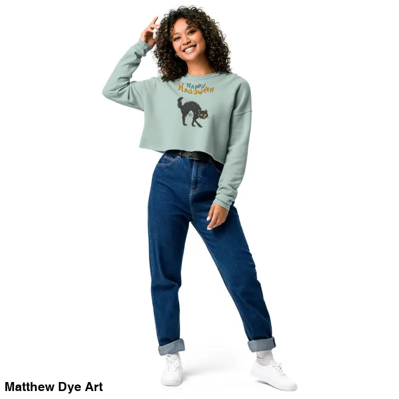 Woman in enchanting mint green cropped sweatshirt featuring a scary cat Halloween design