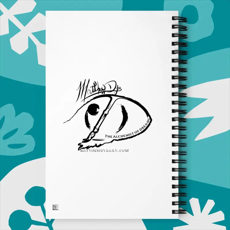 Spiral notebook featuring a black abstract eye design on a white cover for A Gift of the Heart