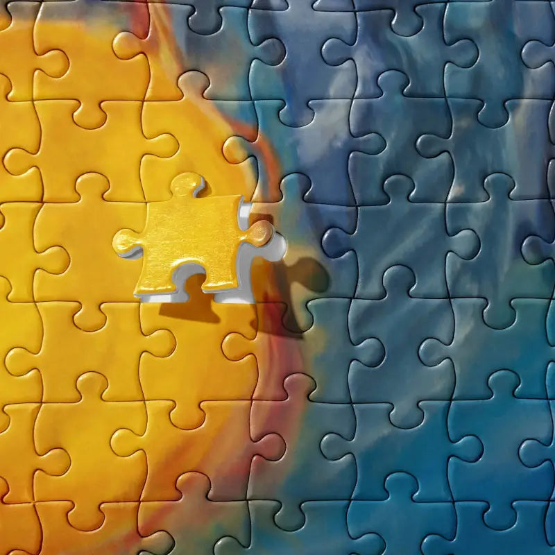 Partially assembled Above and Below Cosmic Jigsaw Puzzle showcasing vibrant yellow and blue art