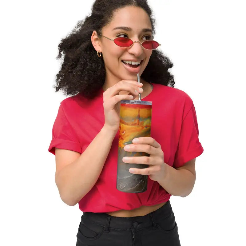 Person in a red t-shirt enjoying a drink from an Elysian Sunset stainless steel tumbler