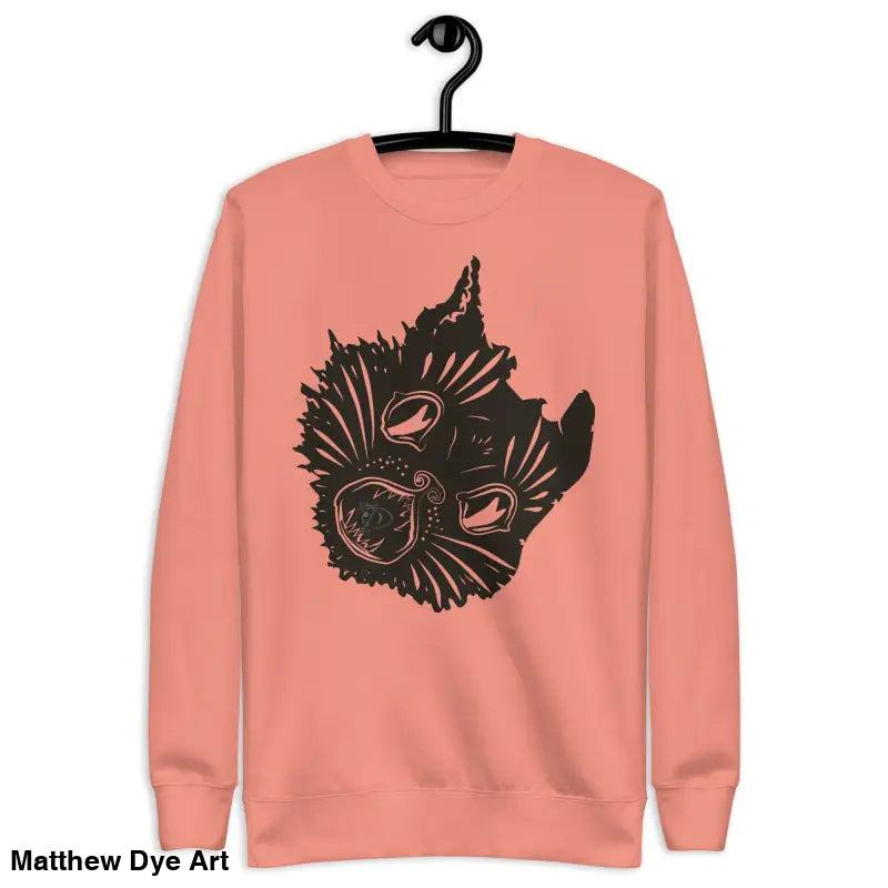 Peach-colored premium spooky sweatshirt featuring black graphic of a kitty head unisex