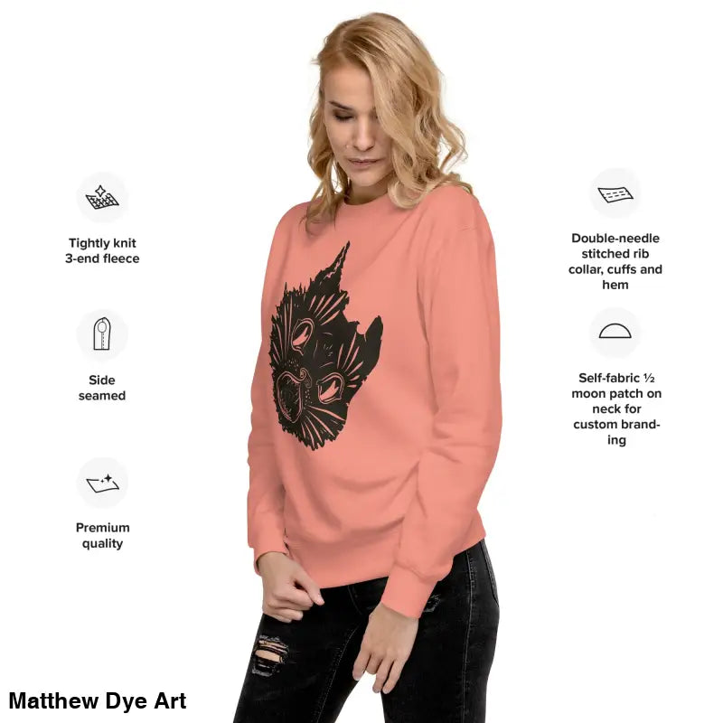 Salmon-colored premium spooky sweatshirt featuring black graphic of kitty head unisex design