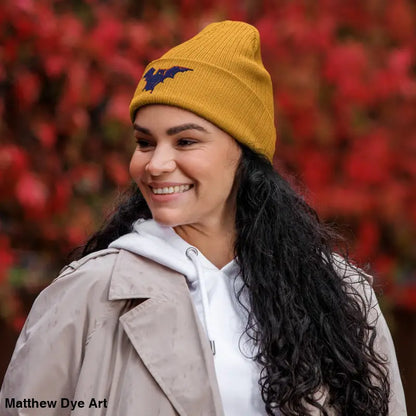 Mustard-yellow knit beanie with bat emblem, perfect for autumn and Halloween wear