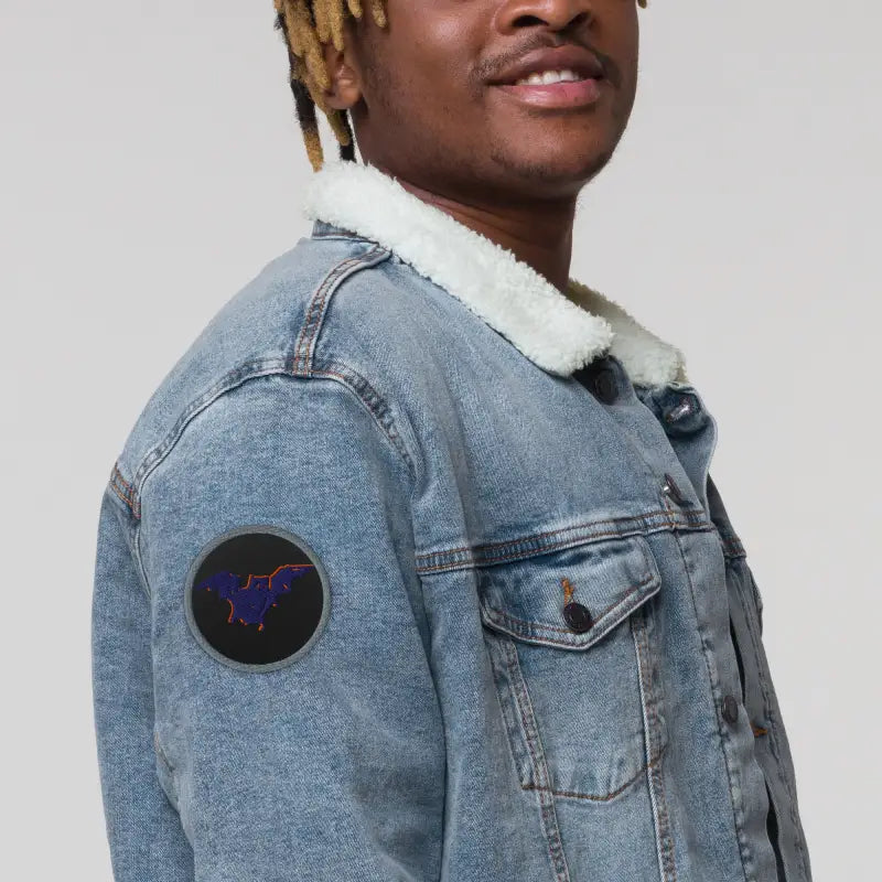 Denim jacket with sherpa collar featuring whimsical bat baby embroidered design