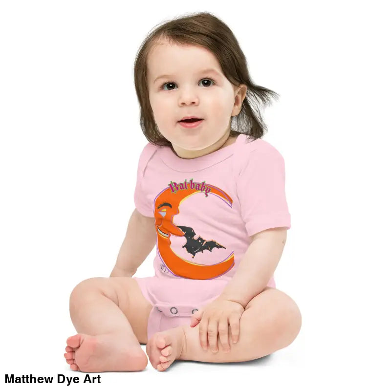 Baby in a pink bat-themed onesie featuring playful retro design made of cotton