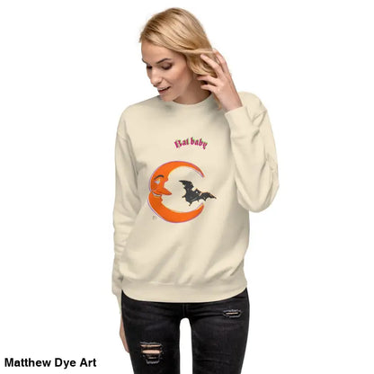 Woman in cream Bat Baby unisex sweatshirt with crescent moon and bat design for Halloween