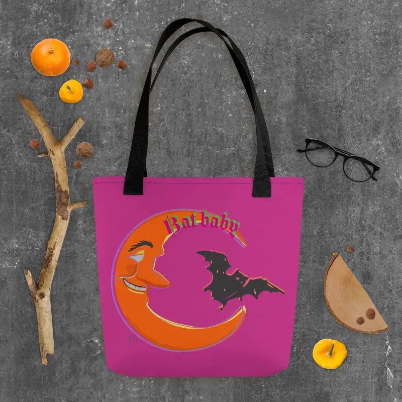 Pink tote bag with a smiling crescent moon and bat design for Halloween trick-or-treat use