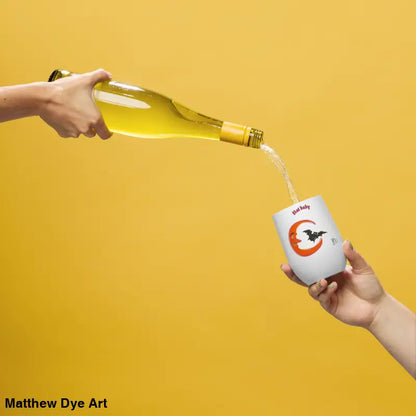 Wine being poured into a Bat Baby stainless steel tumbler for a retro Halloween experience