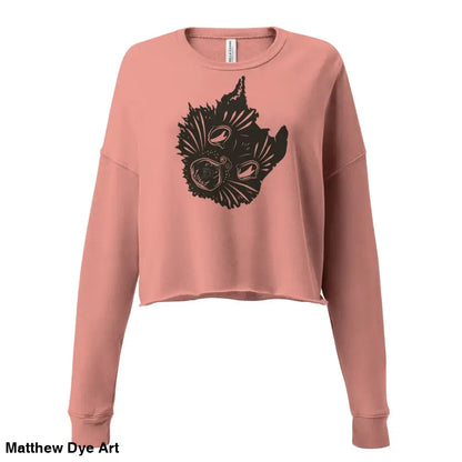 Salmon-colored cropped sweatshirt featuring a spooky season style with a surreal cat design