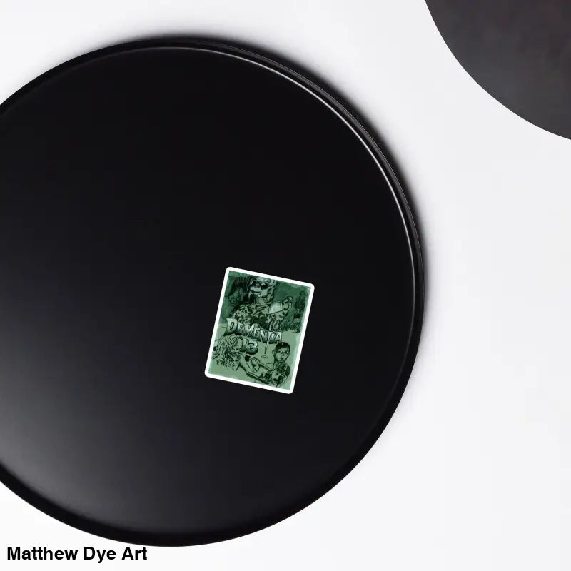 Black circular disc with a green card, featuring Dementia 13 Retro Horror Magnets