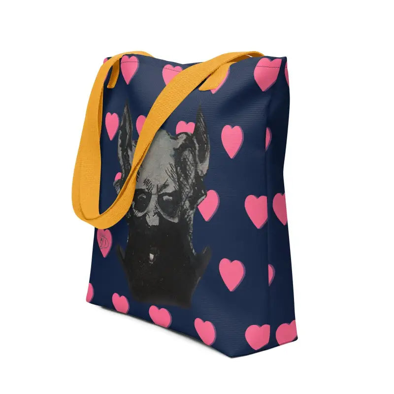 Navy blue tote bag with pink hearts, featuring a sinister demonic figure and yellow straps