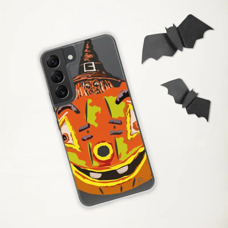 Black smartphone in Pumpkin Witch Clear Case with decorative paper bats and witch hat