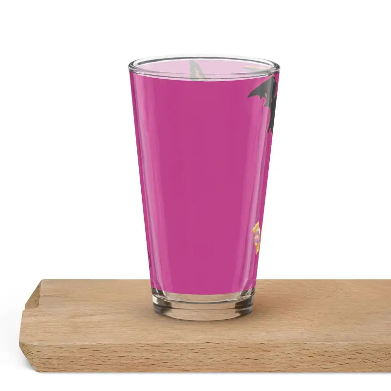 Clear shaker pint glass filled with bright pink liquid for Enchanting Pumpkin Witch