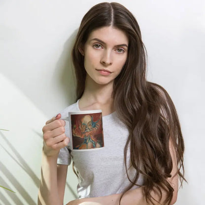 Person with long dark hair holding a haunted ceramic mug featuring Matthew Dye art