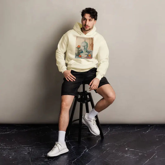 Person in cream Phrenology Unisex Oversized Hoodie, black shorts, and white sneakers