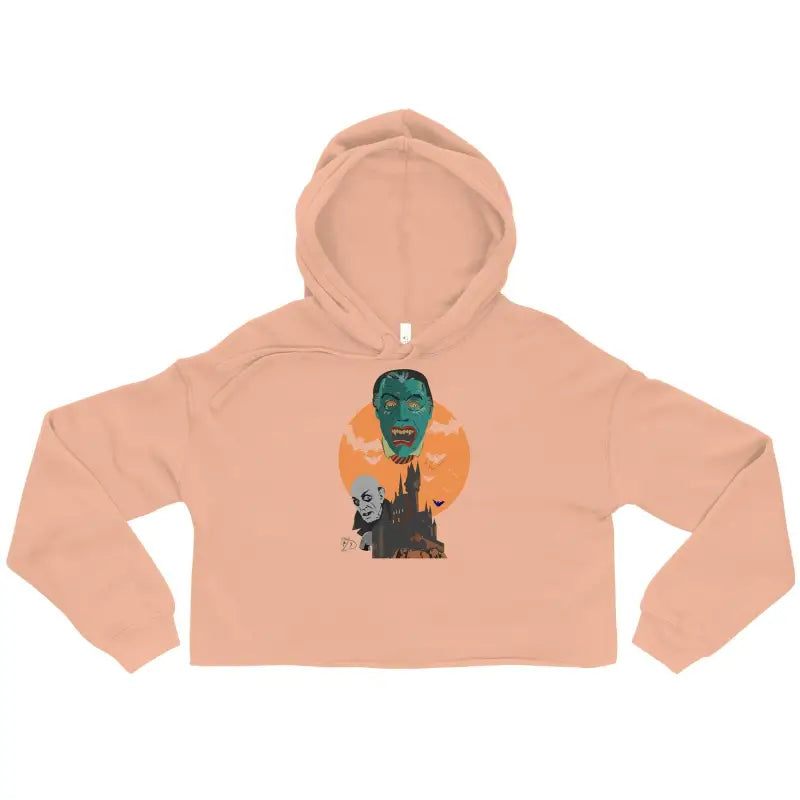 Peach-colored vampires crop hoodie featuring Matthew Dye art of a gothic castle and moon