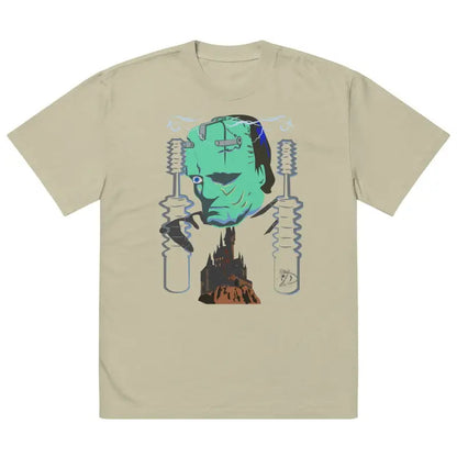 Beige t-shirt with turquoise monster graphic by Matthew Dye Art on dark gray canvas