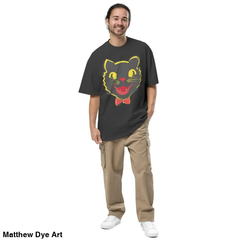 Man in a black cat oversized faded t-shirt and khaki pants, showcasing Vintage Halloween style