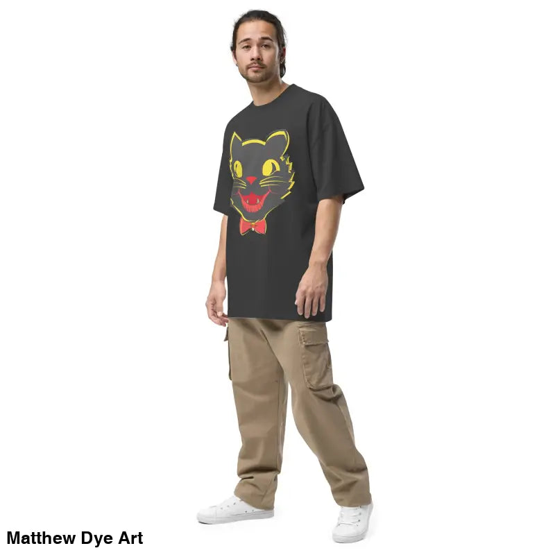 Man modeling vintage cat oversized faded t-shirt featuring a black cat graphic design