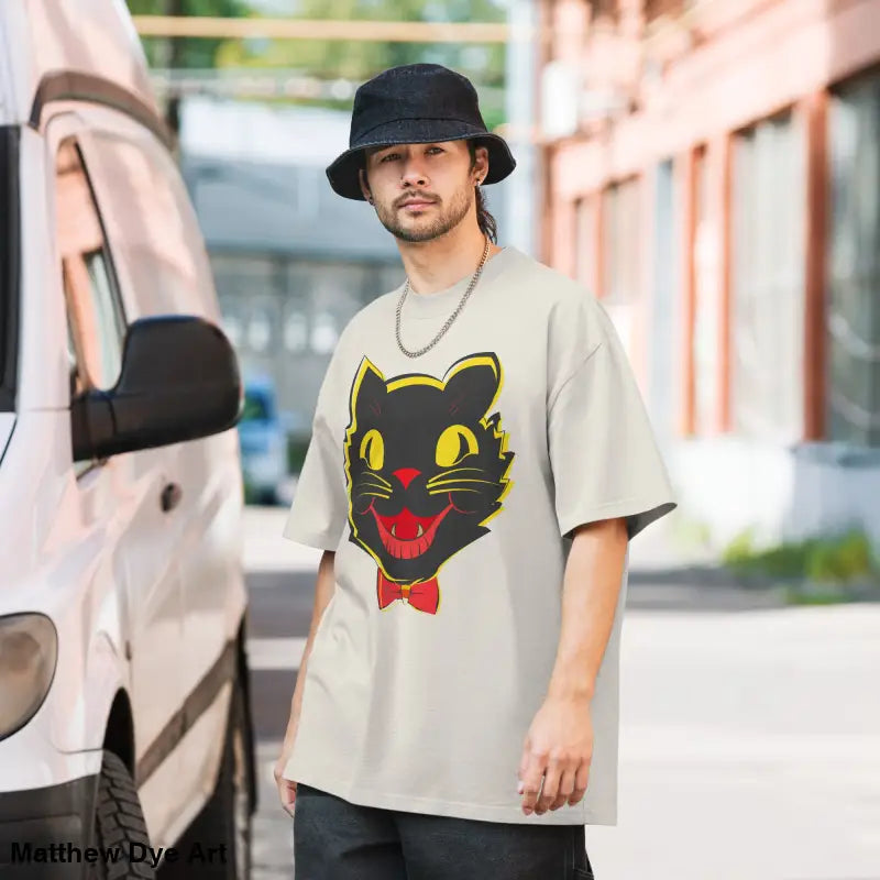 Man models a Grinning Ghoul vintage cat oversized faded t-shirt with a playful design