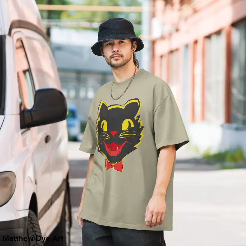 Man wearing a vintage cat oversized faded t-shirt featuring a Grinning Ghoul design