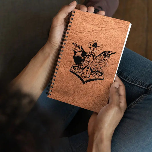 Copper-colored spiral notebook featuring a crown design for Heathen Pride creative expressions