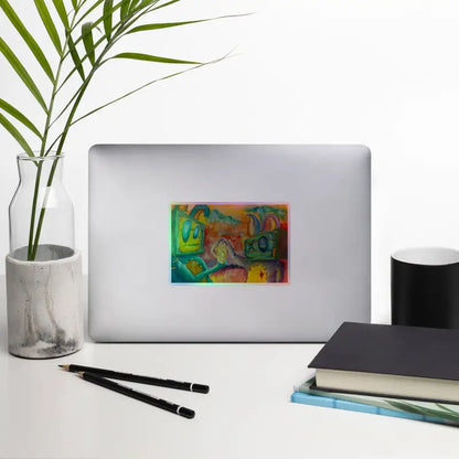 Silver laptop adorned with heart holographic stickers showcasing vivid artistry