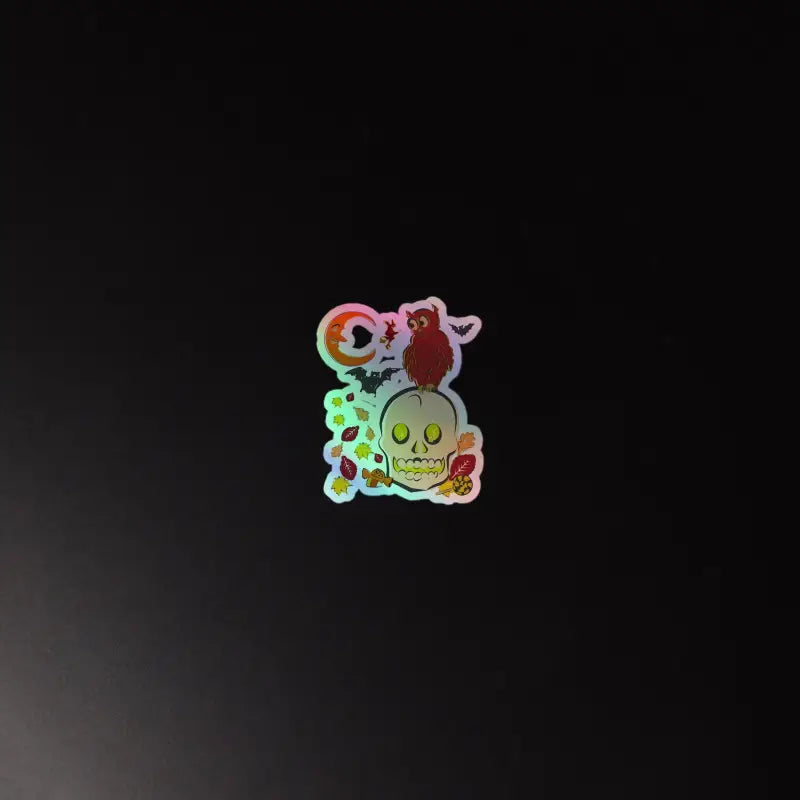 Holographic sticker of a cartoon skull and owl design from Haunted Harvest collection