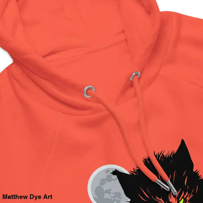 Orange raglan hoodie featuring wolf design with glowing green eyes and candlelit hands