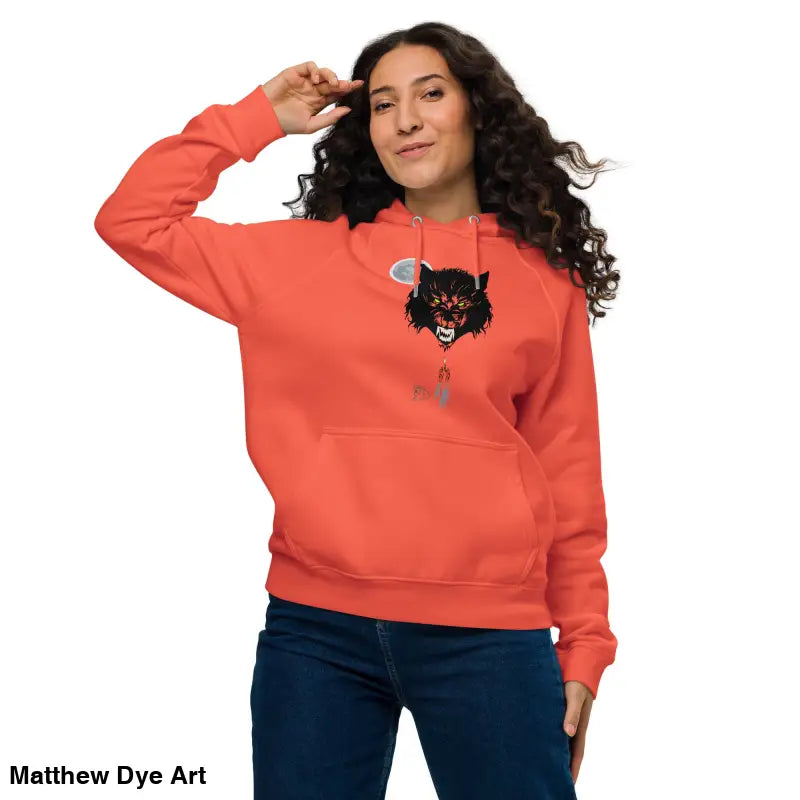Woman wearing orange raglan hoodie featuring glowing green eyes and gothic werewolf art