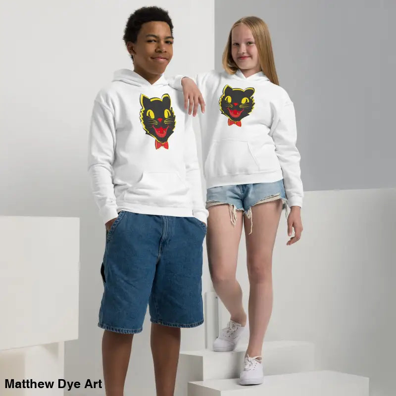 Two children in white vintage cat youth hoodies featuring a black cat design