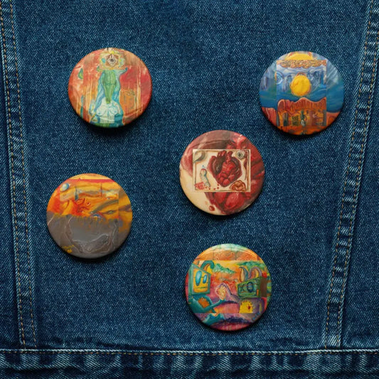 Colorful decorative buttons on denim showcasing Matthew Dye’s Art Pins in Surrealism