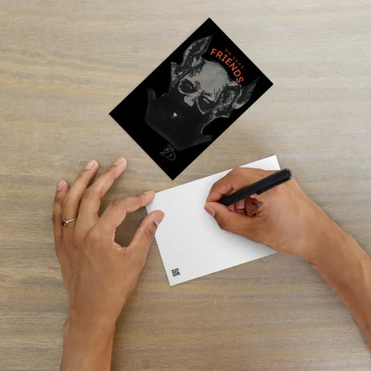 Black postcard featuring a skull graphic on high-quality matte paper for Gothic art lovers