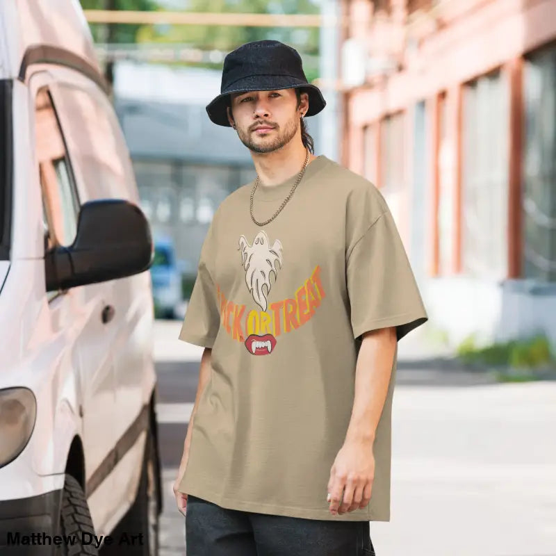 Halloween-themed tan oversized faded t-shirt featuring vampire fangs for treat smiles