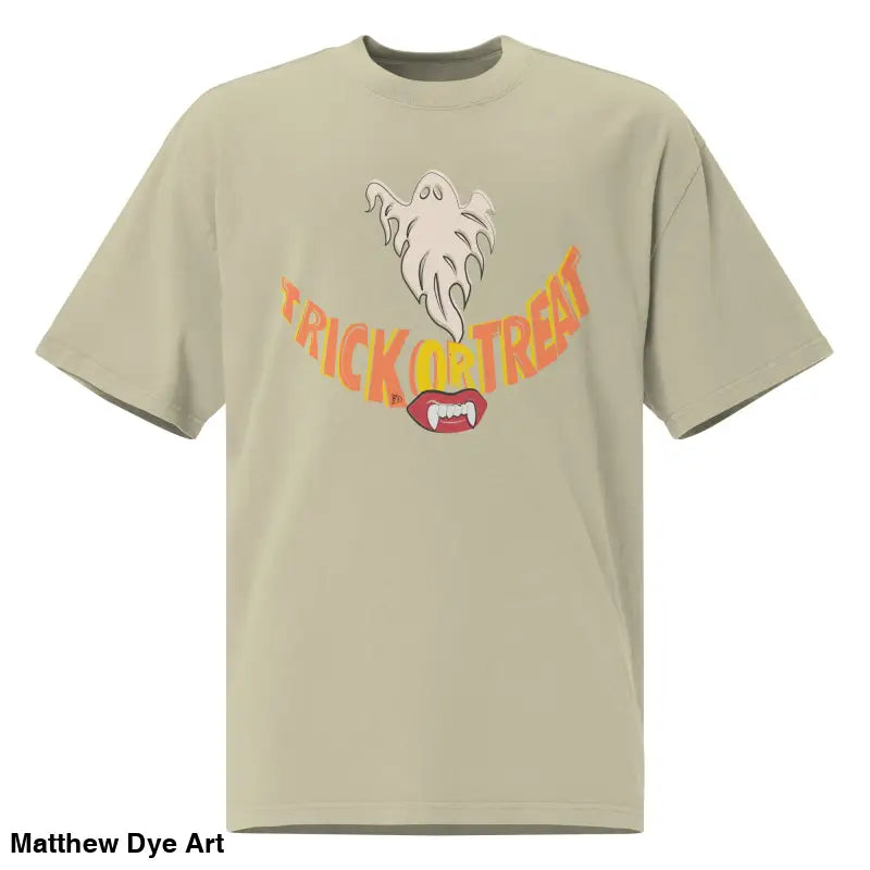 Beige oversized faded t-shirt featuring a Halloween graphic with vampire fangs for treat smiles
