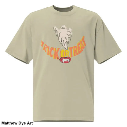 Beige oversized faded t-shirt featuring a Halloween graphic with vampire fangs for treat smiles