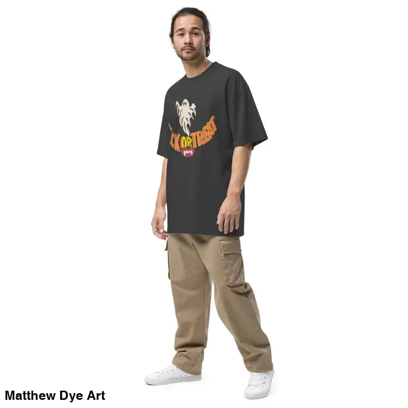 Man in oversized faded t-shirt featuring vampire fangs and cargo pants for Halloween