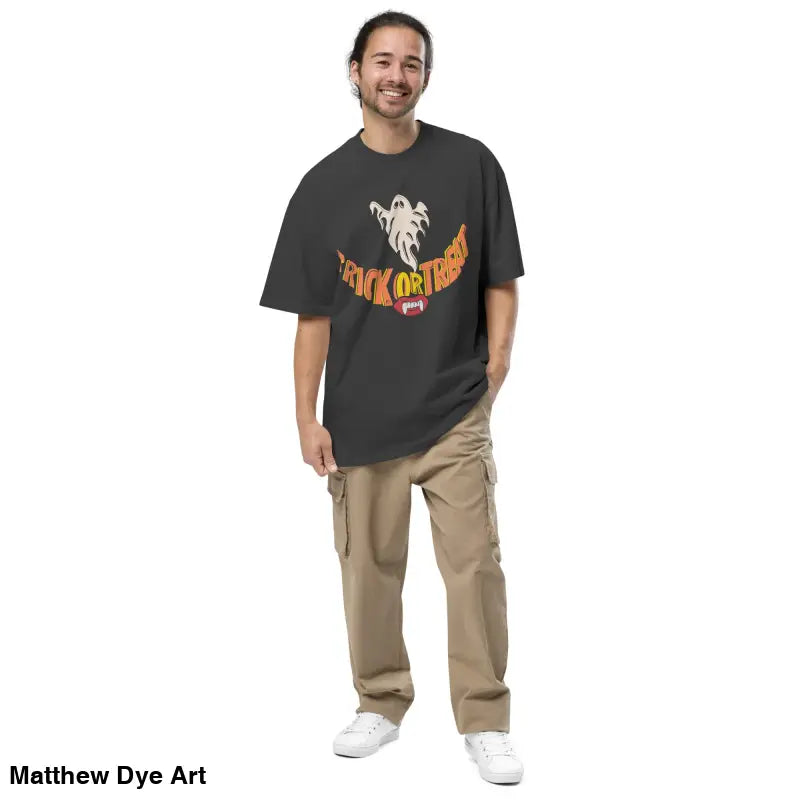 Man wearing oversized faded Halloween tee with vampire fangs and cargo pants