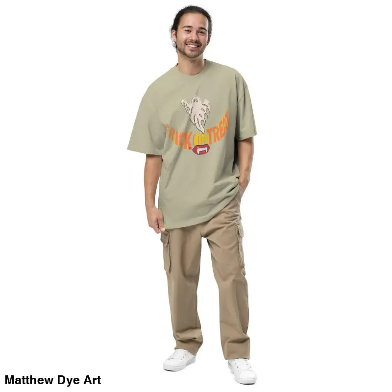 Man in oversized faded t-shirt featuring vampires fangs and Halloween-themed design