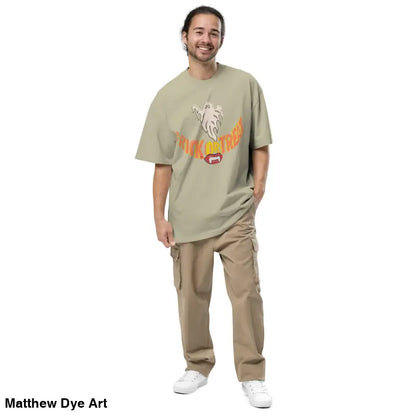 Man in oversized faded t-shirt featuring vampires fangs and Halloween-themed design