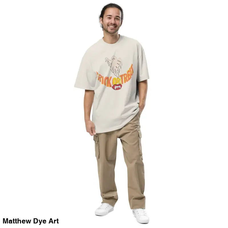 Man in oversized faded t-shirt with Trick or Treat design and cargo pants for Halloween