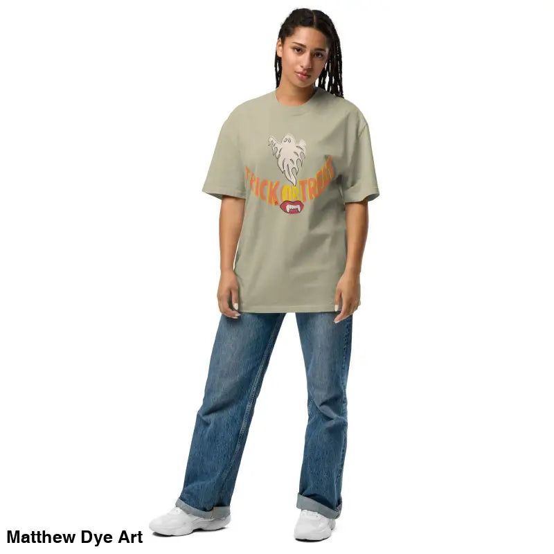 Woman in oversized faded t-shirt, showcasing vampire fangs for Halloween treat smiles