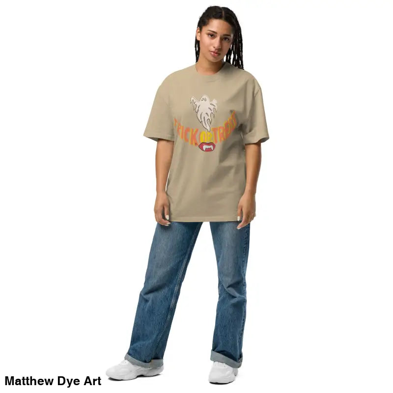 Woman showcasing an oversized faded t-shirt featuring vampire fangs for Halloween treat smiles