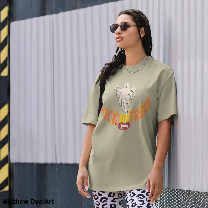 Woman’s oversized faded t-shirt featuring vampire fangs for Halloween treat smiles