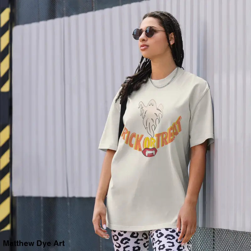 Woman’s oversized faded t-shirt featuring Halloween vampire fangs for treat smiles